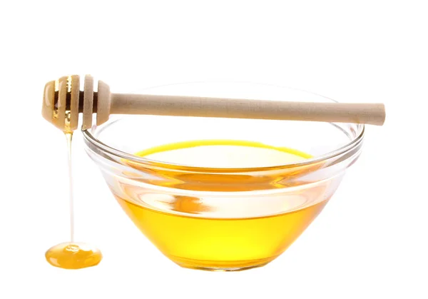 Sød honning i glasskål isoleret på hvid - Stock-foto