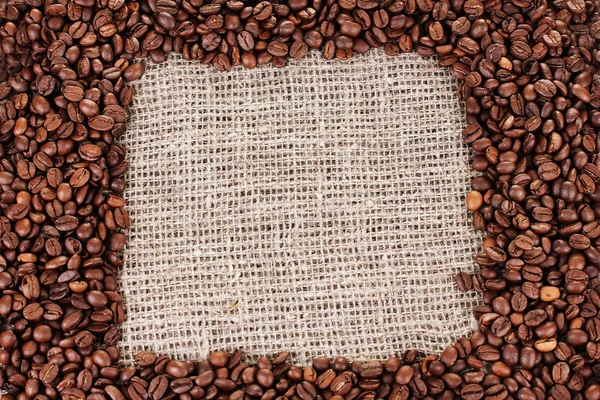 Frame of coffee beans on canvas background — Stock Photo, Image