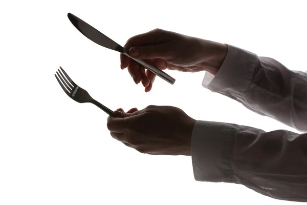 stock image Silhouette of woman's hands with fork and knife isolated on white