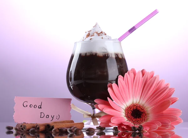 Склянка кавового коктейлю і квітки гербери на фіолетовому фоні — стокове фото