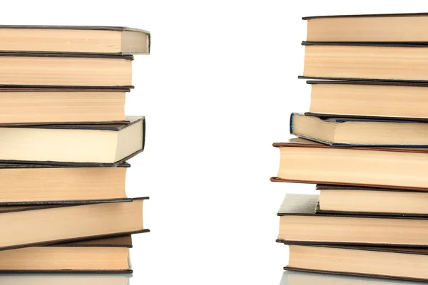 Two towers of books on white background close-up — Stock Photo, Image