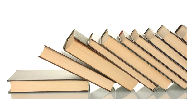 Lutande trave böcker på vit bakgrund — Stockfoto