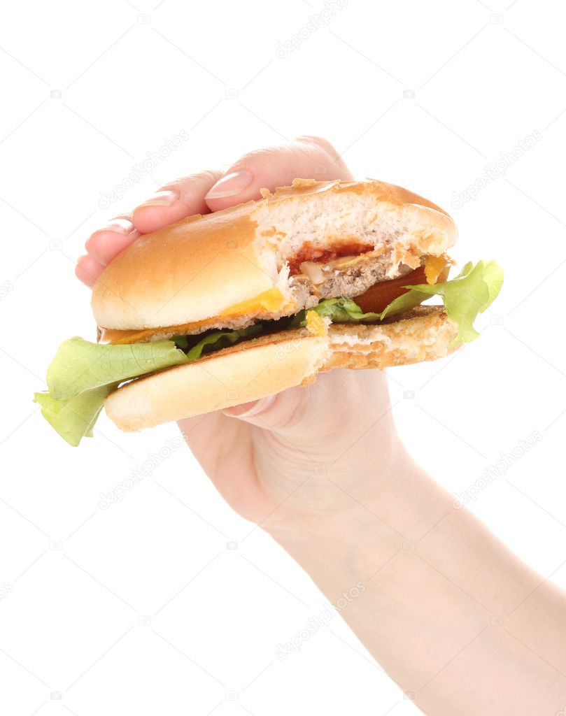 Bitten cheeseburger in hand isolated on white