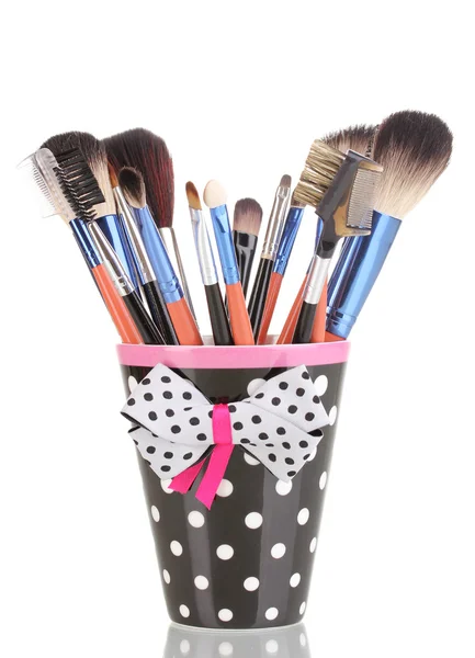 Makeup brushes in a black polka-dot cup isolated on white — Stock Photo, Image