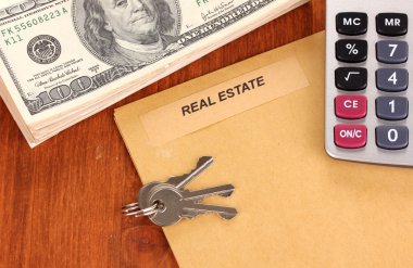 Folder with information of real estate on wooden background close-up clipart