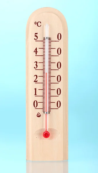 Wooden thermometer on blue — Stock Photo, Image
