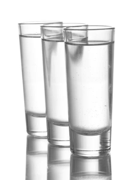 Tres vasos de vodka aislados en blanco —  Fotos de Stock