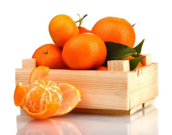 stock image Ripe tasty tangerines with leaves in wooden box isolated on white