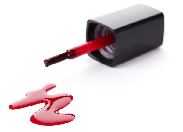Red nail polish and brush isolated on white