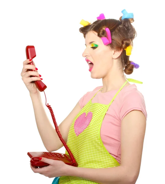 Bela jovem dona de casa com telefone vermelho isolado no branco — Fotografia de Stock