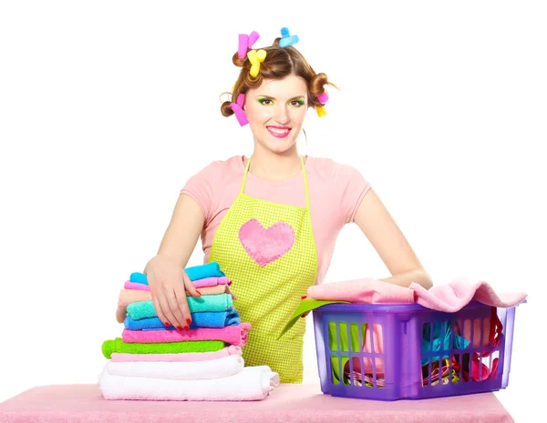 Beautiful young housewife with basket of folded laundry isolated on white — Stock Photo, Image