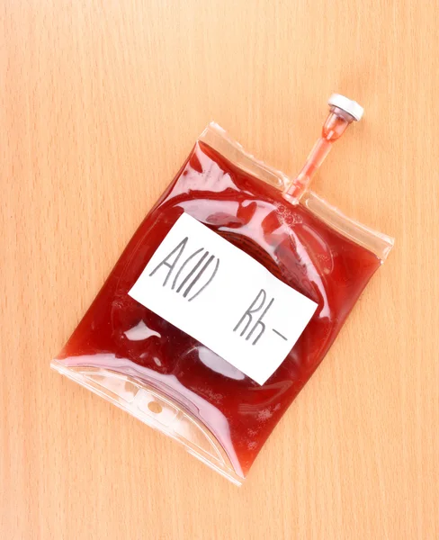 Bag of blood on wooden background — Stock Photo, Image