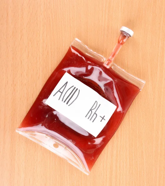 Bag of blood on wooden background — Stock Photo, Image
