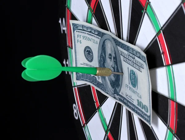 Dollar on bulls eye. Darts close-up on black background — Stock Photo, Image