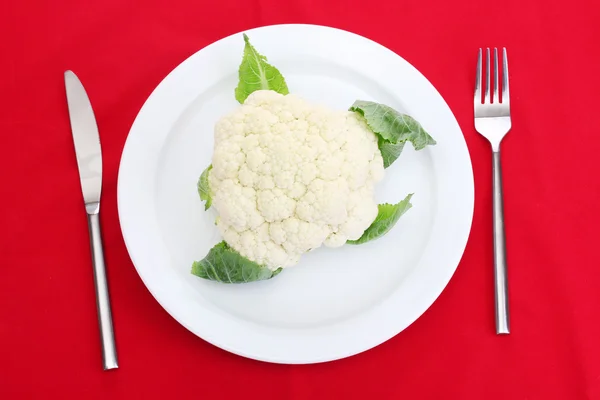 Fresh cauliflower on plate, knife and fork — Stock Photo, Image