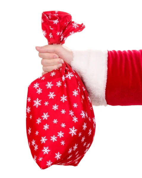 Santa Claus hand holding bag of gifts isolated on white — Stock Photo, Image