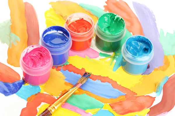 Jars with colorful gouache on a bright picture close-up — Stock Photo, Image