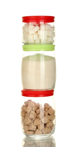 Jars with brown cane sugar lump, white crystal sugar and white lump sugar isolated on white — Stock Photo, Image