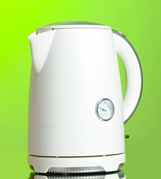 White electric kettle on green — Stock Photo, Image