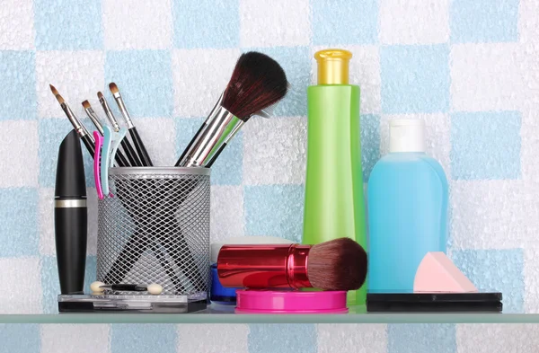 Полка с косметикой и туалетными принадлежностями в ванной комнате — стоковое фото