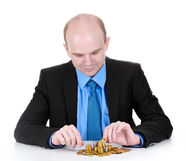 Empresário colocar moedas isoladas em branco — Fotografia de Stock