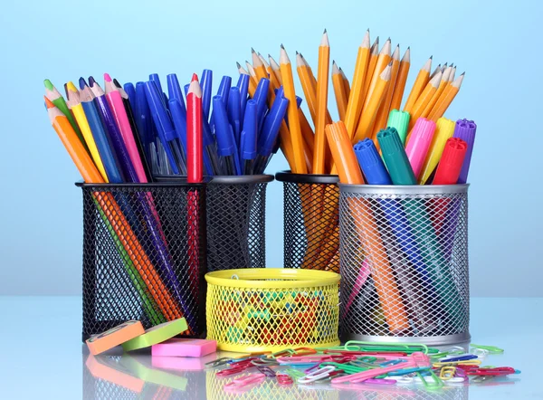 Color holders for office supplies with them on bright background — Zdjęcie stockowe