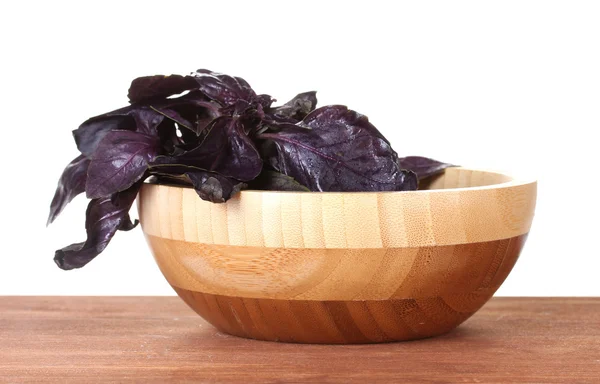 Basil in a wooden bowl on wooden background — Stock Photo, Image