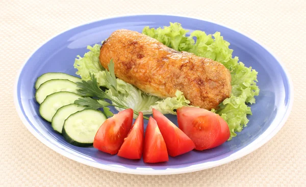 Tasty meat cutlet with garnish on plate — Stock Photo, Image