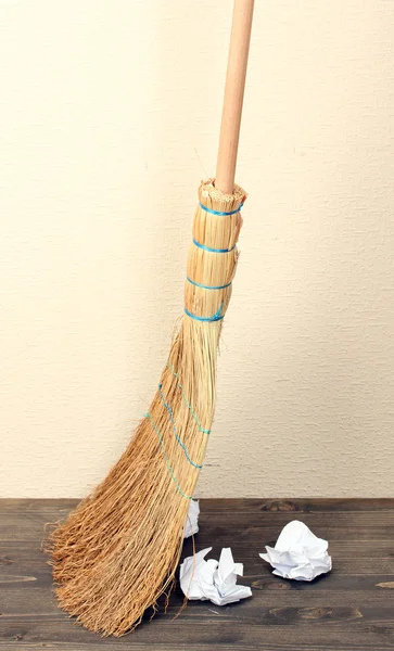Broom and papers on floor in room — Stock Photo, Image