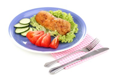 Tasty meat cutlet with garnish on plate isolated on white