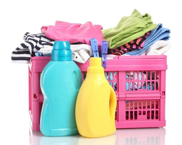 Clothes with detergent in pink plastic basket isolated on white — Stock Photo, Image