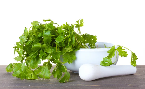 Coriander in a mortar and pestle on wooden — Stock Photo, Image