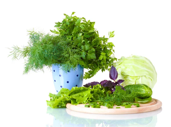 Composition of various herbs on a cutting board and a lilac cup with black polka dots isolated on white — Stock Photo, Image
