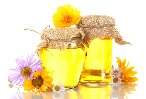 Sweet honey in jars and flowers isolated on white — Stock Photo, Image