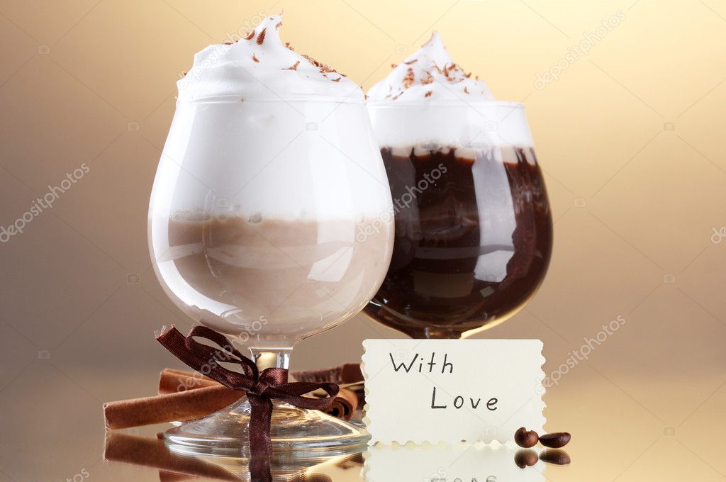 Glasses of coffee cocktail on brown background