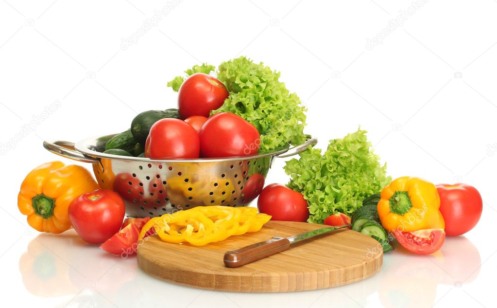 Fresh vegetables and knife on cutting board isolated on white