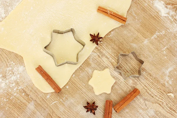 stock image Tins of cookies on the rolled out dough with herbs on a wooden table close-up