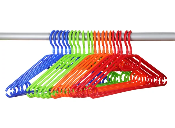 Plastic hangers in row isolated on white — Stock Photo, Image