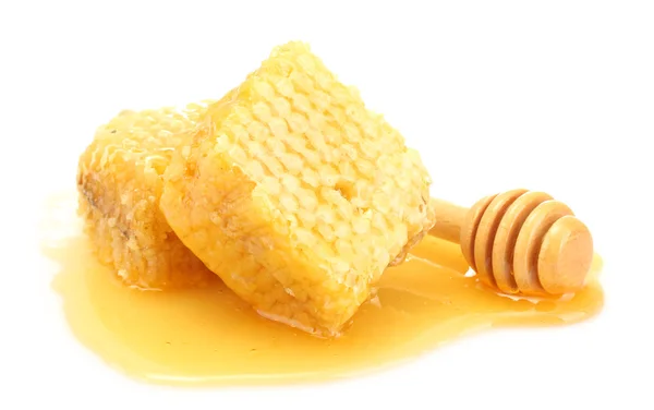Panales dorados y rociador de madera con miel aislada en blanco Imagen de stock