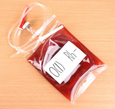 Bag of blood and infusion on wooden background clipart
