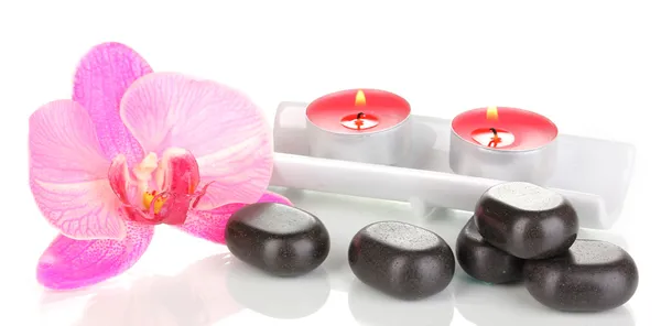 Pietre termali con fiore di orchidea e candele isolate su bianco — Foto Stock