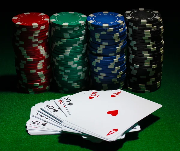 Cards and chips for poker on green table — Stock Photo, Image