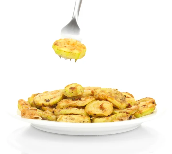 Fried zucchini in a white plate with fork on white background close-up — Stock Photo, Image