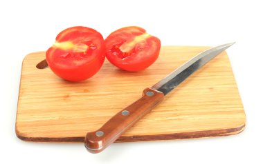 Ripe red tomatoes and knife on cutting board isolated on white clipart