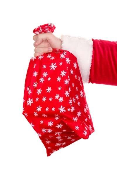 Santa claus ręka trzyma worek prezentów na białym tle — Zdjęcie stockowe