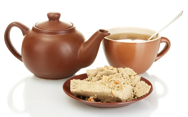 Teapot with cup and saucer with sweet halva isolated on white — Stock Photo, Image
