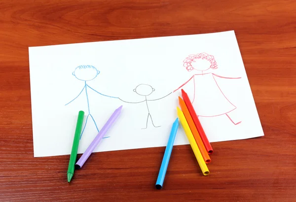 Dibujo infantil de familia y lápices sobre fondo de madera — Foto de Stock