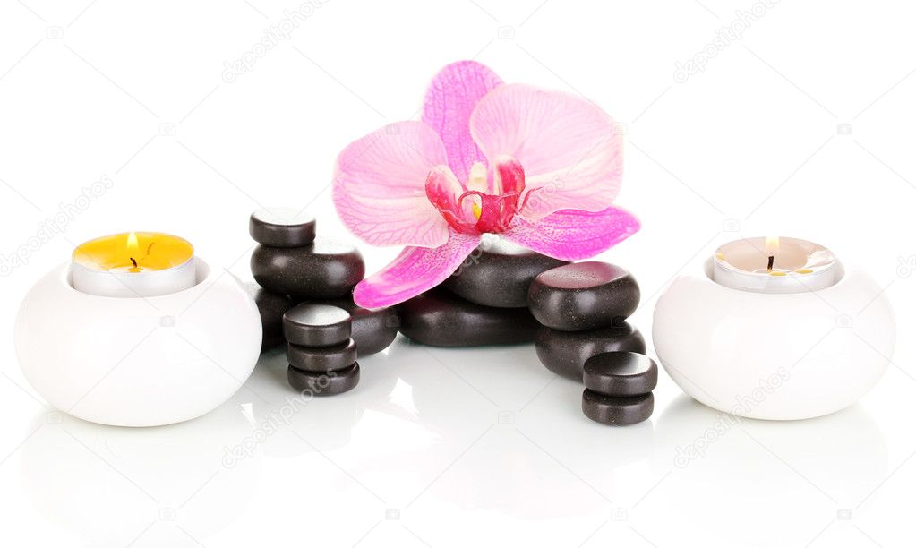 Spa stones with orchid flower and candles isolated on white