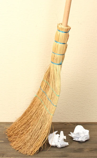Broom and papers on floor in room — Stock Photo, Image