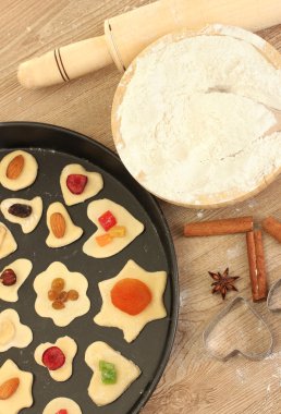 Unbaked cookies with candied fruits and nuts in a pan close-up clipart